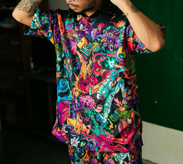 Colorful graphic shirt featuring recent fashion trends people dislike in a vibrant pattern.