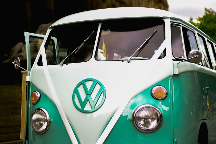 Vintage Volkswagen van parked, featuring teal and white colors, related to dumbest rumors.