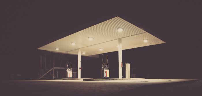 A lone gas station lit up at night, representing improved life simplicity.