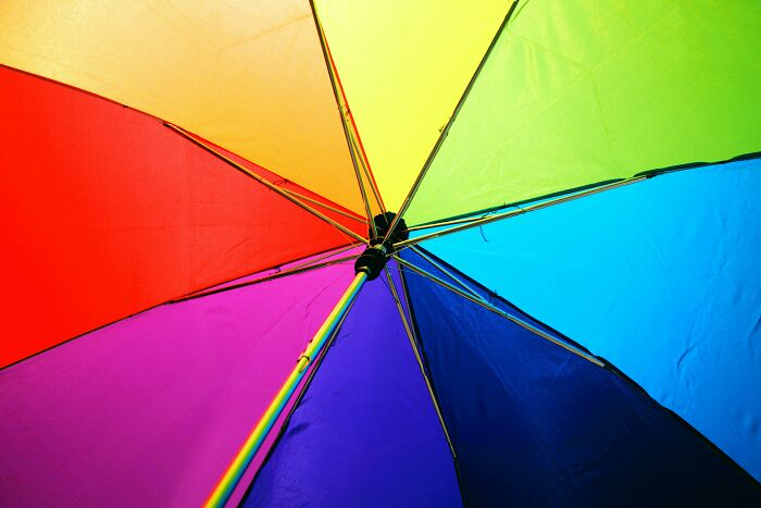 Colorful umbrella open indoors, related to superstitions about bad luck.