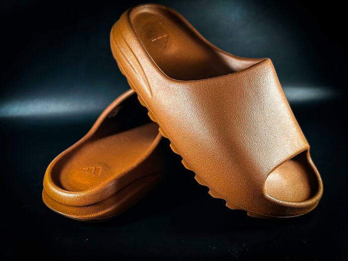 Durable brown slides, beautifully designed for longevity, against a black background.