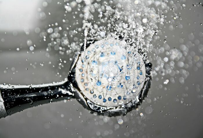 Showerhead spraying water droplets, related to hilarious overheard conversations.