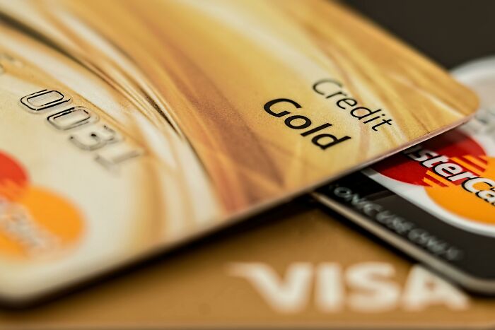 Close-up of credit cards, including a gold card, illustrating life cheat codes for smarter living.