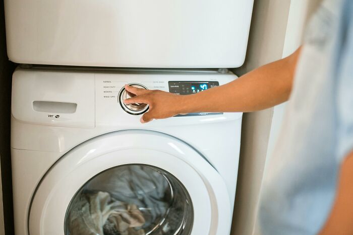 Person using a washer, representing self-paying-products concept.