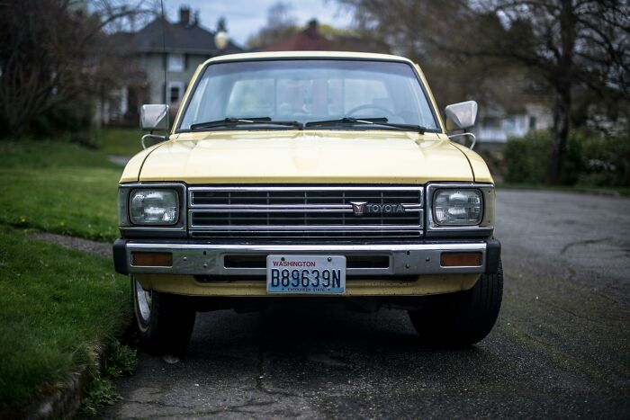 Yellow Toyota truck parked on a residential street, promoting concepts of self-paying-products in everyday use.