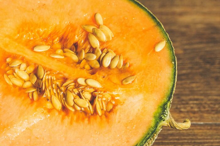 Close-up of a sliced cantaloupe with seeds, highlighting health-boosting fruits.