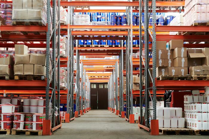 Warehouse storage shelves filled with boxed and canned goods, showcasing an organized workplace moment.