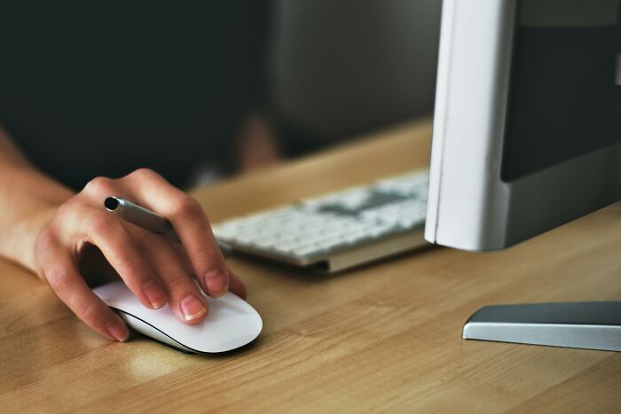 Person using a computer mouse at a desk, focusing on work skills people lack.