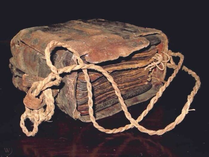 Ancient, weathered book bound with a rope, illustrating something interesting from history.