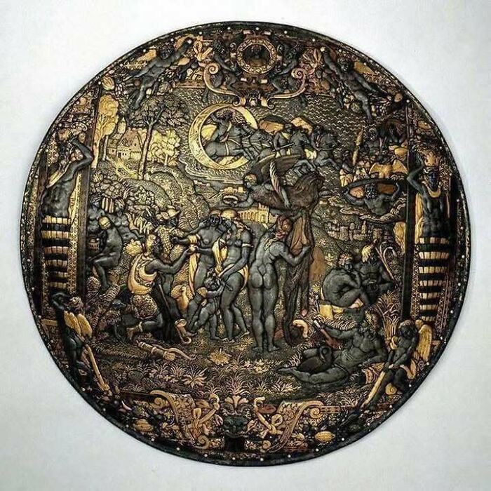 Intricately detailed historical artifact showcasing scenes from history with figures in a round, ornate design.