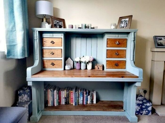 Recycled furniture piece with drawers, adorned with candles and books, showcasing creative reuse in interior design.