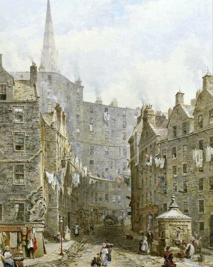 Historic city street scene with people, old buildings, and laundry hanging across in a bygone era.