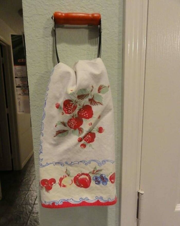 Towel with strawberry pattern on a vintage paper towel holder, inspiring recycling decor ideas.