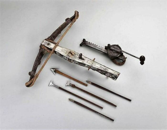 Medieval crossbow and bolts display, showcasing historical weaponry.
