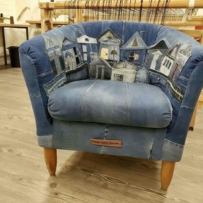 Recycled denim chair with a cityscape design, showcasing creative recycling.