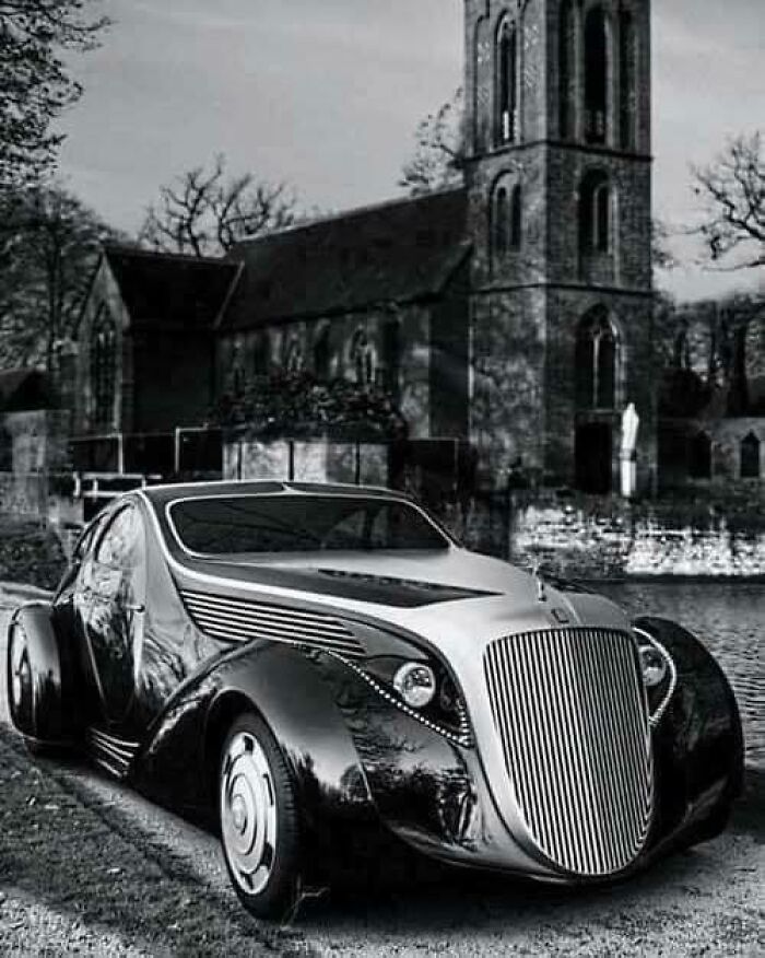 Vintage car parked in front of an old church, showcasing automotive history with elegant design.
