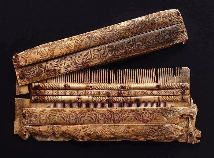 Ancient intricately carved wooden comb, showcasing historical craftsmanship.
