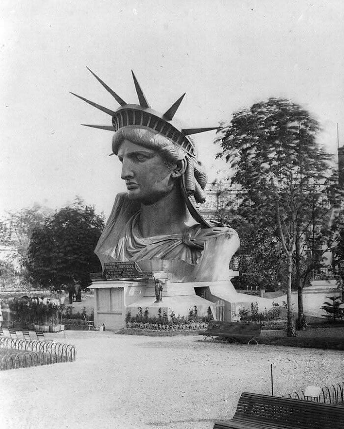 Statue of Liberty's head displayed in a park during construction; a fascinating moment in history.