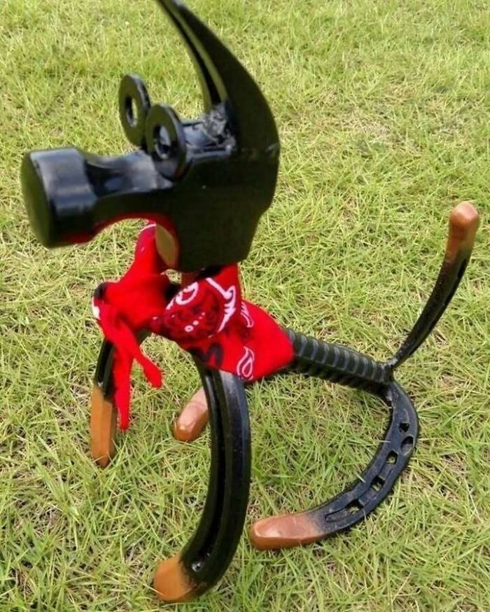 Upcycled animal sculpture made from recycled tools on grass.