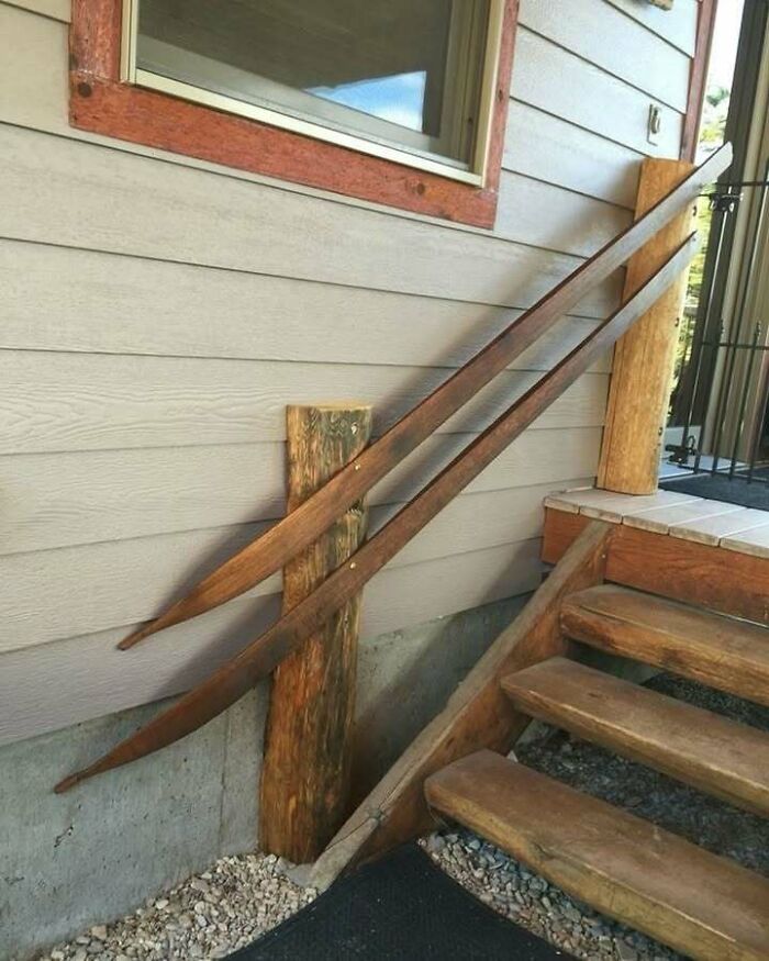 Rustic stairs with recycled wood and ski poles as a railing, showcasing creative recycling.
