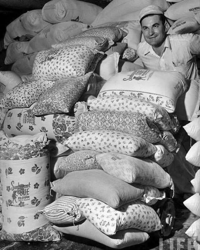 Man in vintage photo with flour sacks, showcasing interesting historical packaging designs.