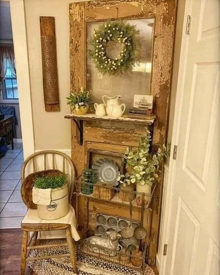 Recycled decor with plants and vintage items displayed on a rustic wooden shelf.
