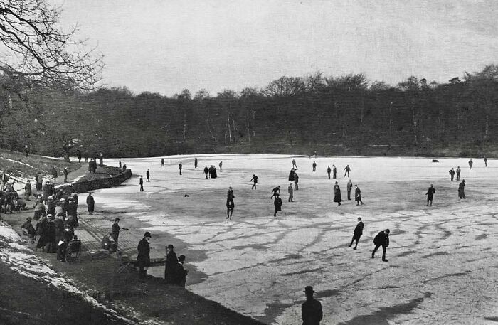 People skating on a frozen pond, early 20th century, capturing historical moments in winter leisure activities.