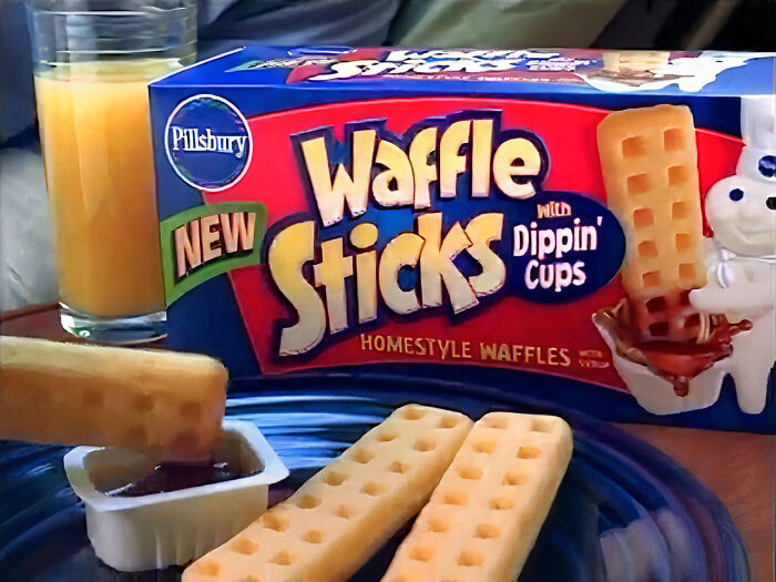 Pillsbury Waffle Sticks with syrup dipping cups, a vanished food item from the 90s and 2000s, and a glass of juice.