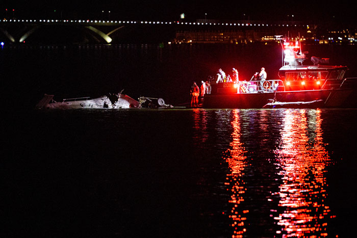 Rescue boats near crash site at night following Black Hawk drill in DC waters.