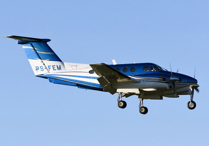 A small blue and white aircraft in flight, related to recent aviation disaster news.