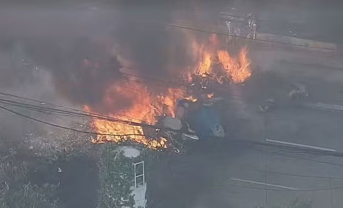 Burning wreckage from a plane crash into a bus in a latest aviation disaster on a city street.