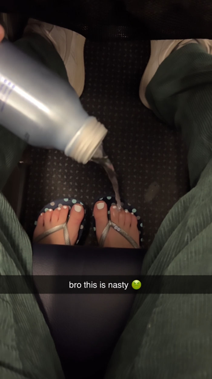 Passenger's bare feet in airplane aisle, water poured on them, video captures "instant karma" moment.