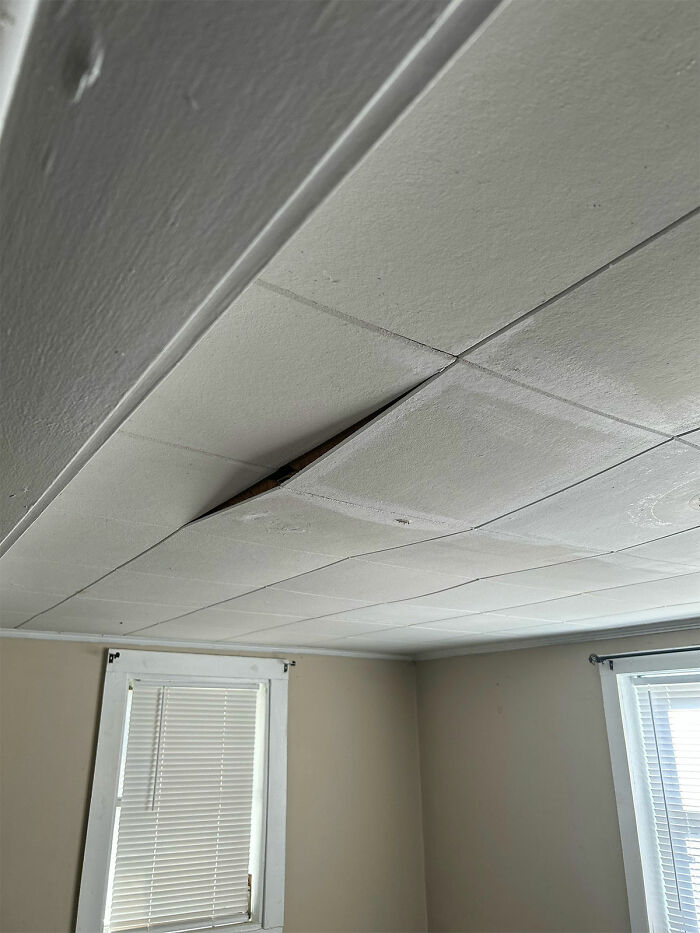 Ceiling with a missing tile, illustrating a moment that makes people question reality in movies.