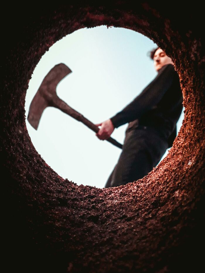 Man with pickaxe seen from ground level, creating a humorous movie moment misconception.