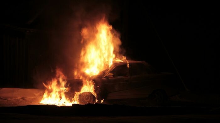Burning car scene highlighting unrealistic movie moments.