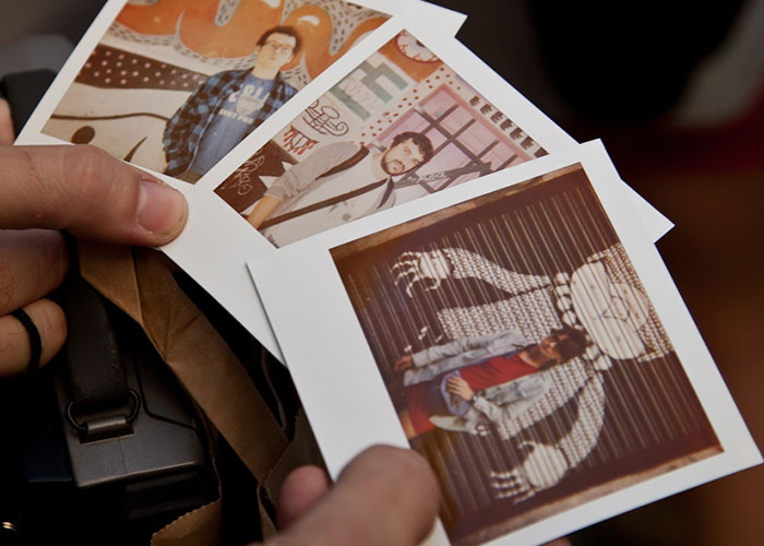 Polaroid photos in hand, showcasing products that failed despite being good.