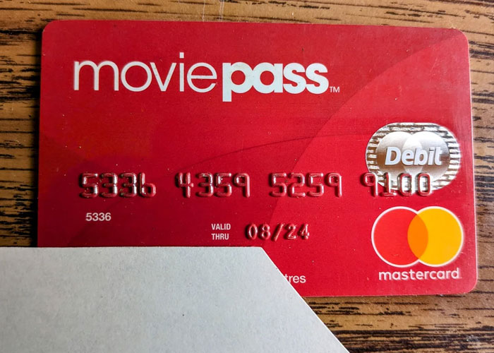 MoviePass debit card on a wooden table, showcasing products that failed despite being good.