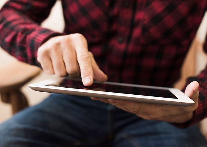 A person uses a tablet, showcasing a product that failed despite being good.