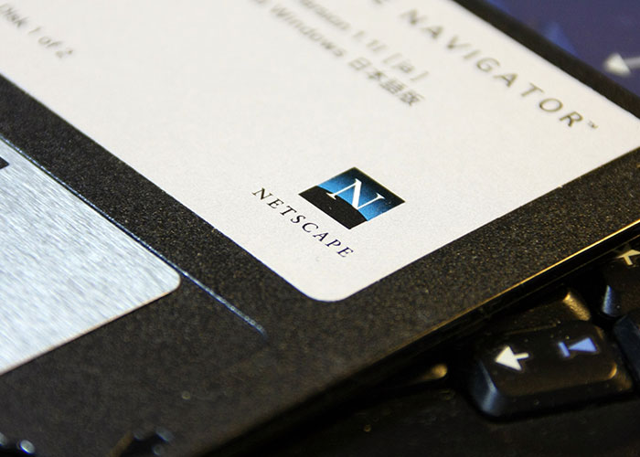 Netscape Navigator floppy disk, a product that failed despite its quality, resting on a keyboard.