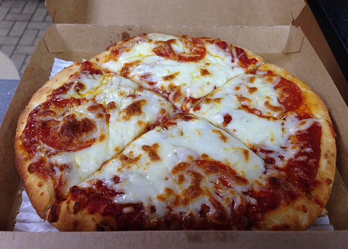 Pizza product that failed despite being good, shown in a cardboard box with melted cheese and pepperoni slices.