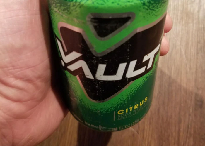 Hand holding a can of Vault citrus soda, a product that failed despite being good.