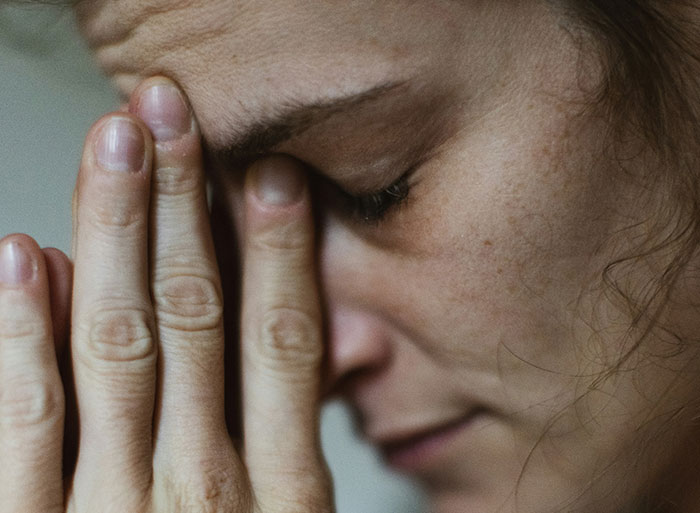 Close-up of a person looking stressed, symbolizing the moment of quitting their job on the spot.