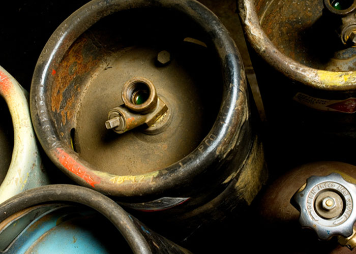 Rusty beer kegs stacked closely, top view, representing an industrial setting related to job quits.