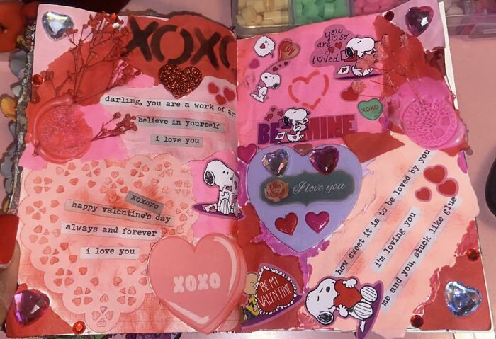 Valentine's gift idea: Handmade scrapbook with Snoopy and heart stickers, featuring loving messages and decorations.