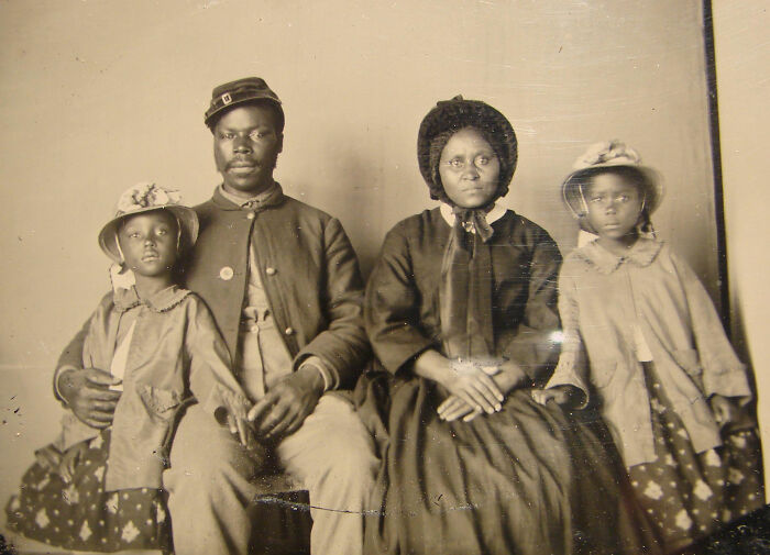 Vintage photo of an African American family in 19th-century attire, highlighting rare historical moments.