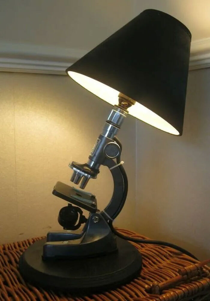 Microscope repurposed as a lamp, highlighting creative recycling.
