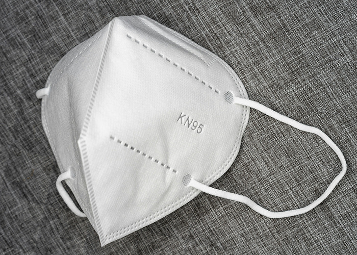 KN95 mask on gray fabric, symbolizing proactive measures for women preparing for RFK Jr. as Health Secretary.