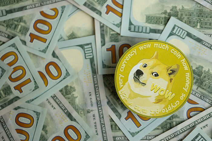 Cryptocurrency-themed coin on scattered 100 dollar bills, symbolizing overnight wealth.