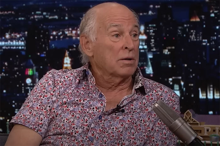 Man in a floral shirt speaking into a microphone during a TV interview, related to rudest celeb encounters.