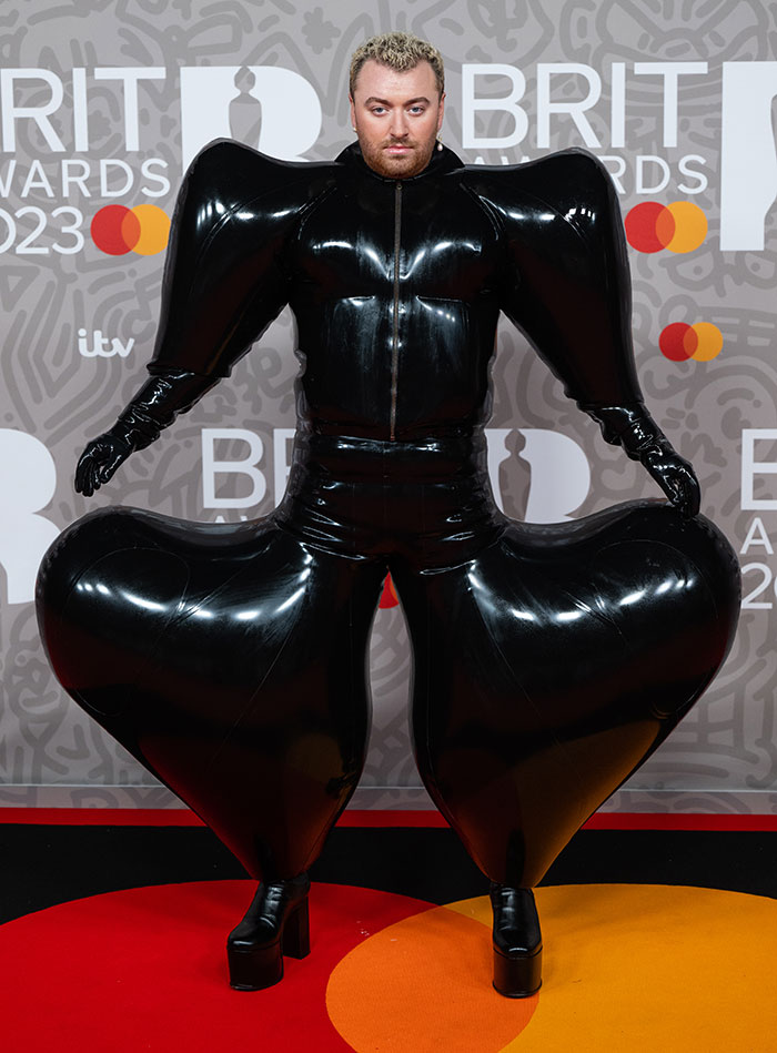 Celebrity in a bold, black inflatable outfit at the Brit Awards, showcasing an unconventional fashion statement.